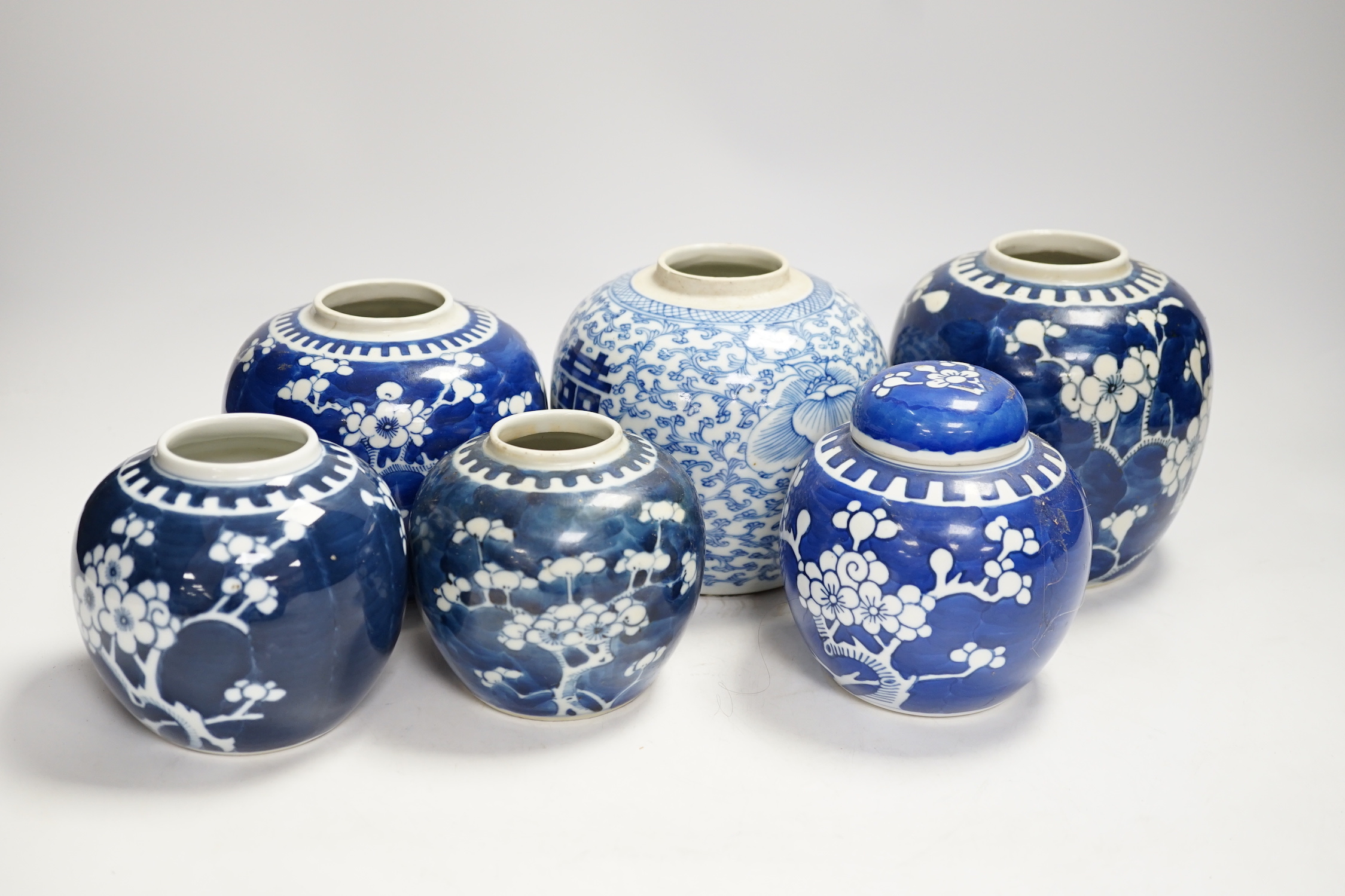 A Chinese blue and white 'shuangxi' jar, and seven blue and white 'prunus' jars and one cover, largest 14cm high (8)